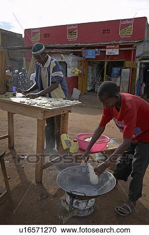 Stock Image -  food uganda young men making chapattis karagi . Fotosearch