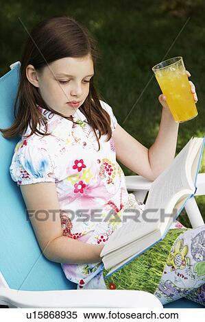girl child book holding glass juice reading 10-11 View Large Photo Image Stock Photography - girl child book holding glass juice reading 10-11. Fotosearch