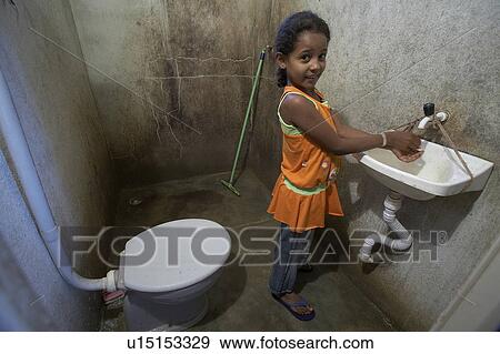 Stock Photo -  girl child children brazil washing hands serra . Fotosearch