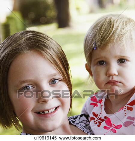 Stock Photography -  girl child children portrait carrying sister . Fotosearch