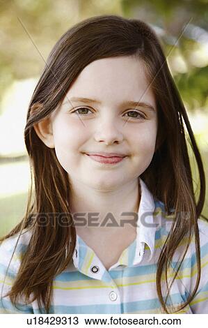 Stock Image -  girl child portrait smiling 8-9 years brown hair. Fotosearch
