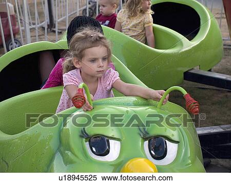 Stock Photography -  girl young waits patiently in carnival ride. Fotosearch