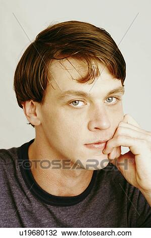 Stock Image -  hand man portrait young thinking chin 20-24 years. Fotosearch