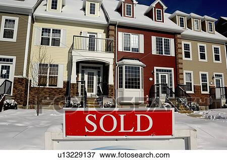 Stock Photo -  house home image red sold sign in front new town. Fotosearch