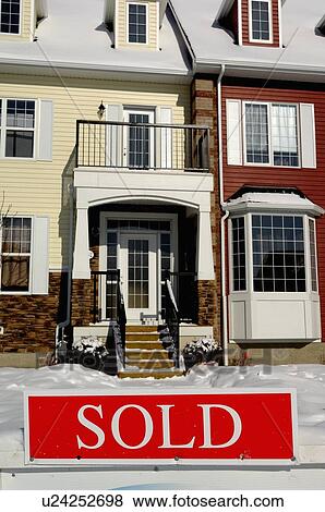 Stock Photo -  house home image red sold sign in front new town. Fotosearch
