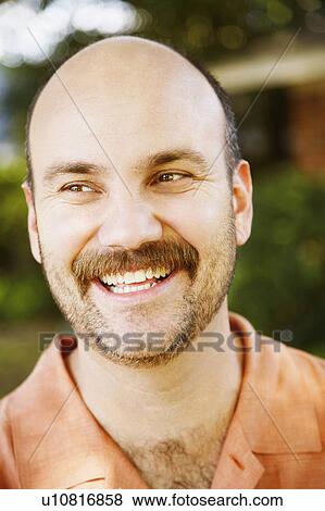 Stock Photo -  man closeup mid adult smiling looking sideways. Fotosearch