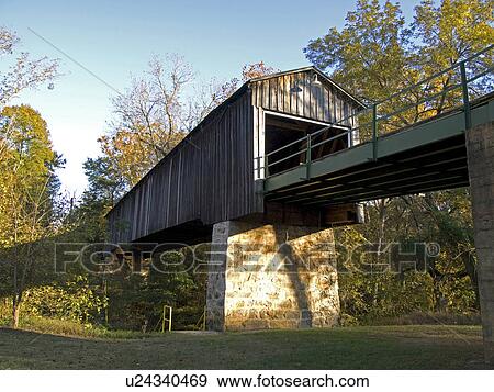 Stock Photo -  man euharlee covered bridge known creek or lowry. Fotosearch
