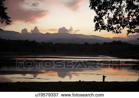 man guatemala sunset over lake lemoa el quiche  View Large Photo Image Stock Photo -  man guatemala sunset over lake lemoa el quiche . Fotosearch