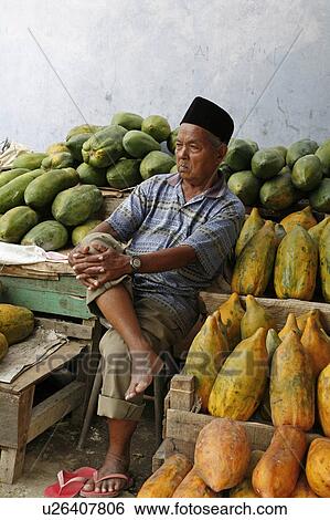 Stock Photograph -  man indonesia selling papayas banda aceh 2 years . Fotosearch