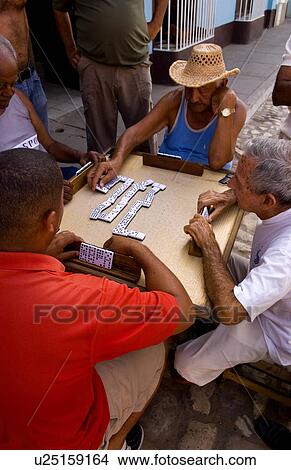 Picture -  men playing dominos street old colonial village. Fotosearch
