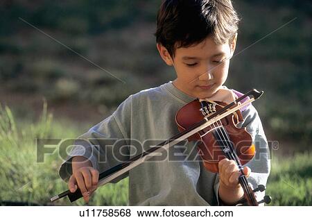 Stock Photo -  music child person art kid boy practicing violin. Fotosearch