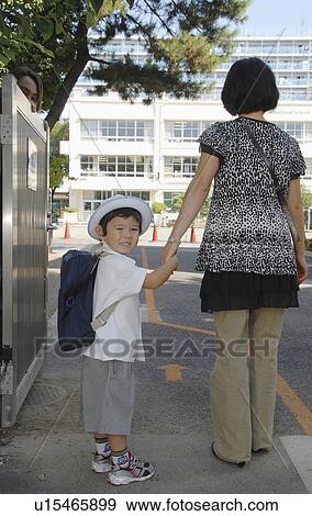 Stock Photo -  school first day ready for asian boy mother. Fotosearch