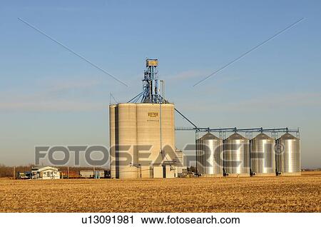 Stock Image -  side view tall concrete grain storage elevator. Fotosearch
