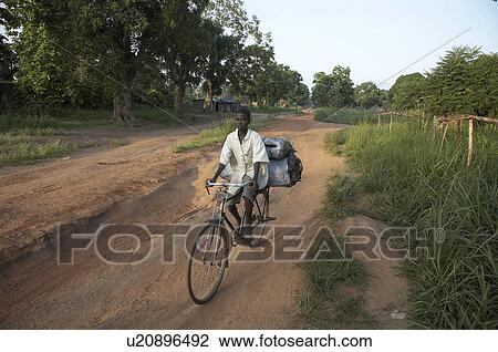 Stock Image -  south sudan boy carrying charcoal bicycle yei on. Fotosearch