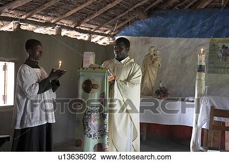 Stock Image -  south sudan catholic mass in simple mud thatch . Fotosearch