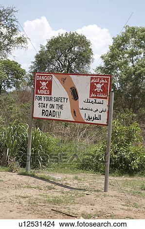 Picture -  south sudan sign warning drivers stay road or to. Fotosearch