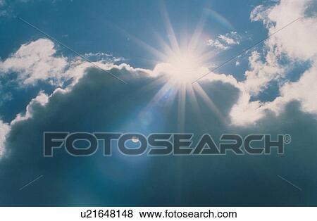 Stock Photo -  sun breaks through clouds bright brightness day. Fotosearch