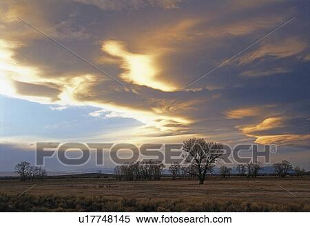 Stock Photography -  sun late afternoon storm clouds over san luis. Fotosearch