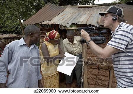 Stock Image -  uganda making mud wood burning cooking stove . Fotosearch