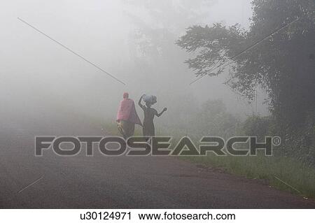 Stock Image -  uganda walking in mist early morning kayunga . Fotosearch