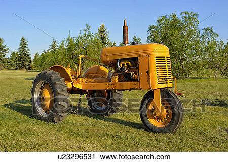 Stock Image -  vintage beauty image antique yellow farm tractor. Fotosearch