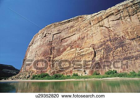 Stock Image -  water desert varnish tints duneformed cliffs . Fotosearch