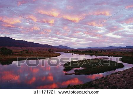 water fall storm clouds tinted sunrise reflected View Large Photo Image Stock Image - water fall storm clouds tinted sunrise reflected. Fotosearch