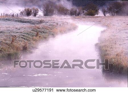 Stock Image -  water fog rises off small stream chilly fall . Fotosearch