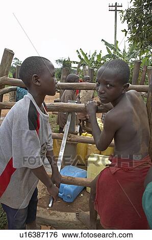 Stock Photograph -  water hand child children uganda pumped borehole . Fotosearch