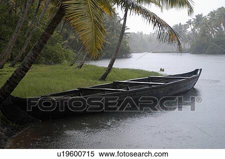 Stock Photography -  water nature lone boat in waiting monsoon day. Fotosearch