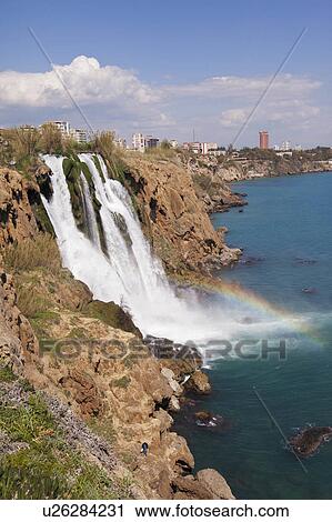 Stock Image -  water waterfall tumbling off cliff sea in karpuz. Fotosearch