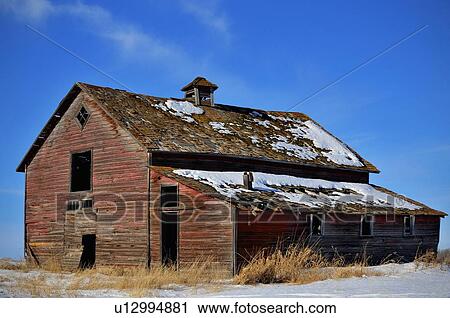Stock Image -  winter horozontal scenic old unused red barn. Fotosearch