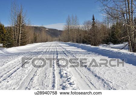 Stock Photo -  winter image snow covered straight section rural. Fotosearch