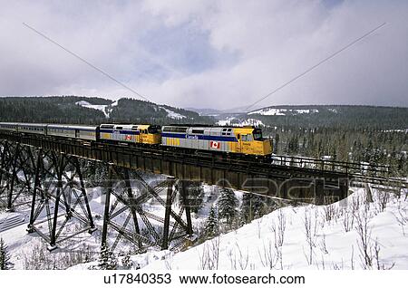 Stock Image -  winter shot via rail passenger train crossing. Fotosearch