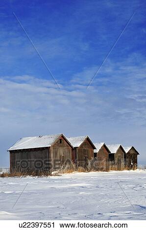 Stock Image -  winter vertical scenic line old type grain sheds. Fotosearch
