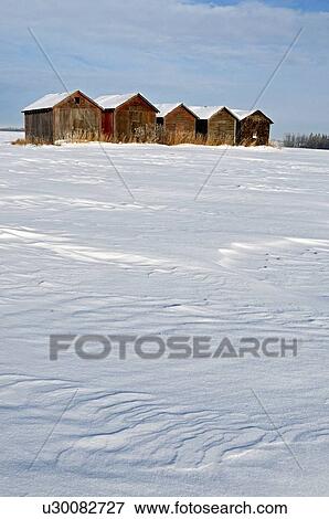Stock Photo -  winter vertical scenic line old type grain sheds. Fotosearch
