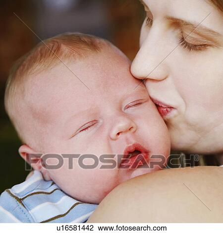 Stock Image -  woman baby closeup young kissing son 12-15 months. Fotosearch