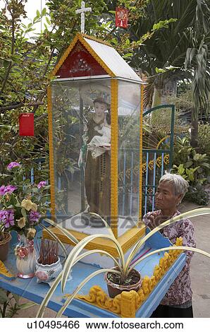 Stock Photograph -  woman cambodia praying in front statue catholic . Fotosearch