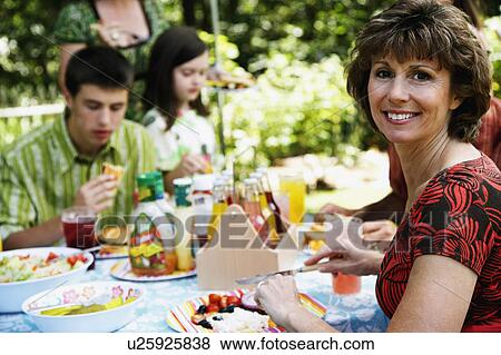 Stock Photo -  woman child side profile mature smiling table. Fotosearch