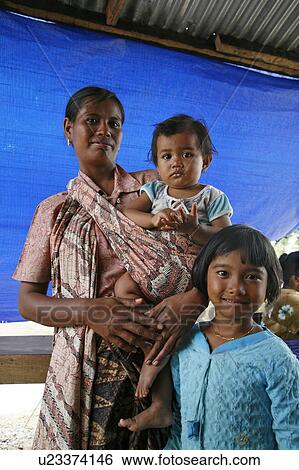 Stock Photograph -  woman child women indonesia crs housing project . Fotosearch