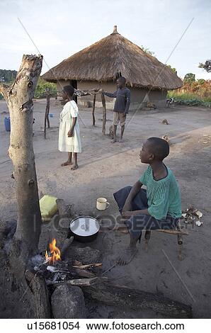 Picture -  woman children fire women south sudan early farm . Fotosearch