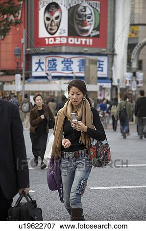 Stock Photo -  woman japan shibuya tokyo cellphone asia se woman. Fotosearch