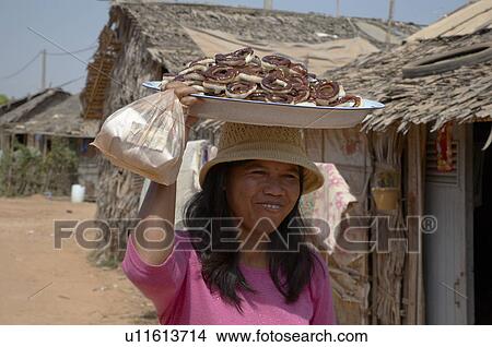 Picture -  woman people women cambodia selling donuts anlon . Fotosearch