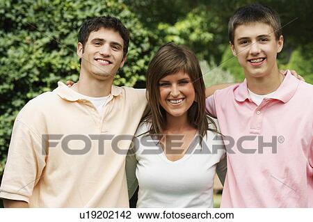 Stock Image -  woman portrait young two brothers in park 16-17. Fotosearch