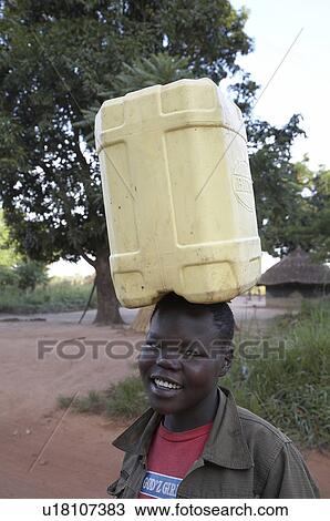 Stock Image -  woman water hand women south sudan carrying pump . Fotosearch