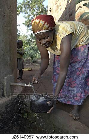 Stock Photo -  woman water home women uganda in najjemba taking . Fotosearch