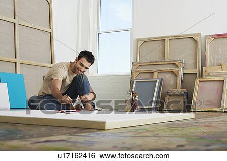 Artist painting on canvas lying on studio floor View Large Photo Image Stock Photograph - Artist painting on canvas lying on studio floor. Fotosearch