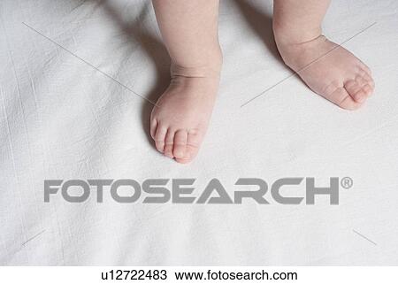 Stock Image - Baby (6-12 months), close up of feet. Fotosearch
