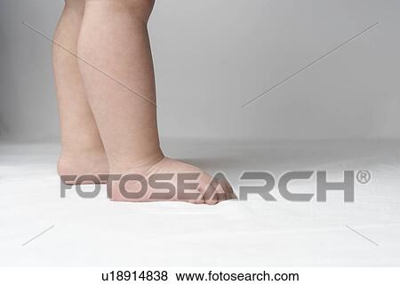 Baby (6-12 months) standing, low section View Large Photo Image Stock Photo - Baby (6-12 months) standing, low section. Fotosearch