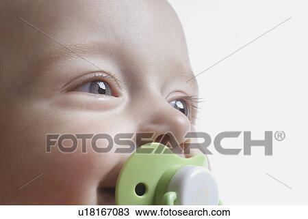 Baby (6-12 months) with pacifier, smiling, close up View Large Photo Image Stock Image - Baby (6-12 months) with pacifier, smiling, close up. Fotosearch